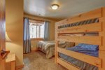 Big Bear Lodge downstairs bedroom with bunks and full bed.